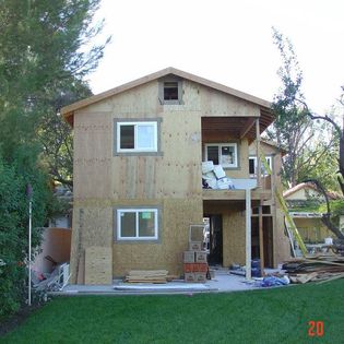 Two-story home addition with window installation by Hillstar Construction