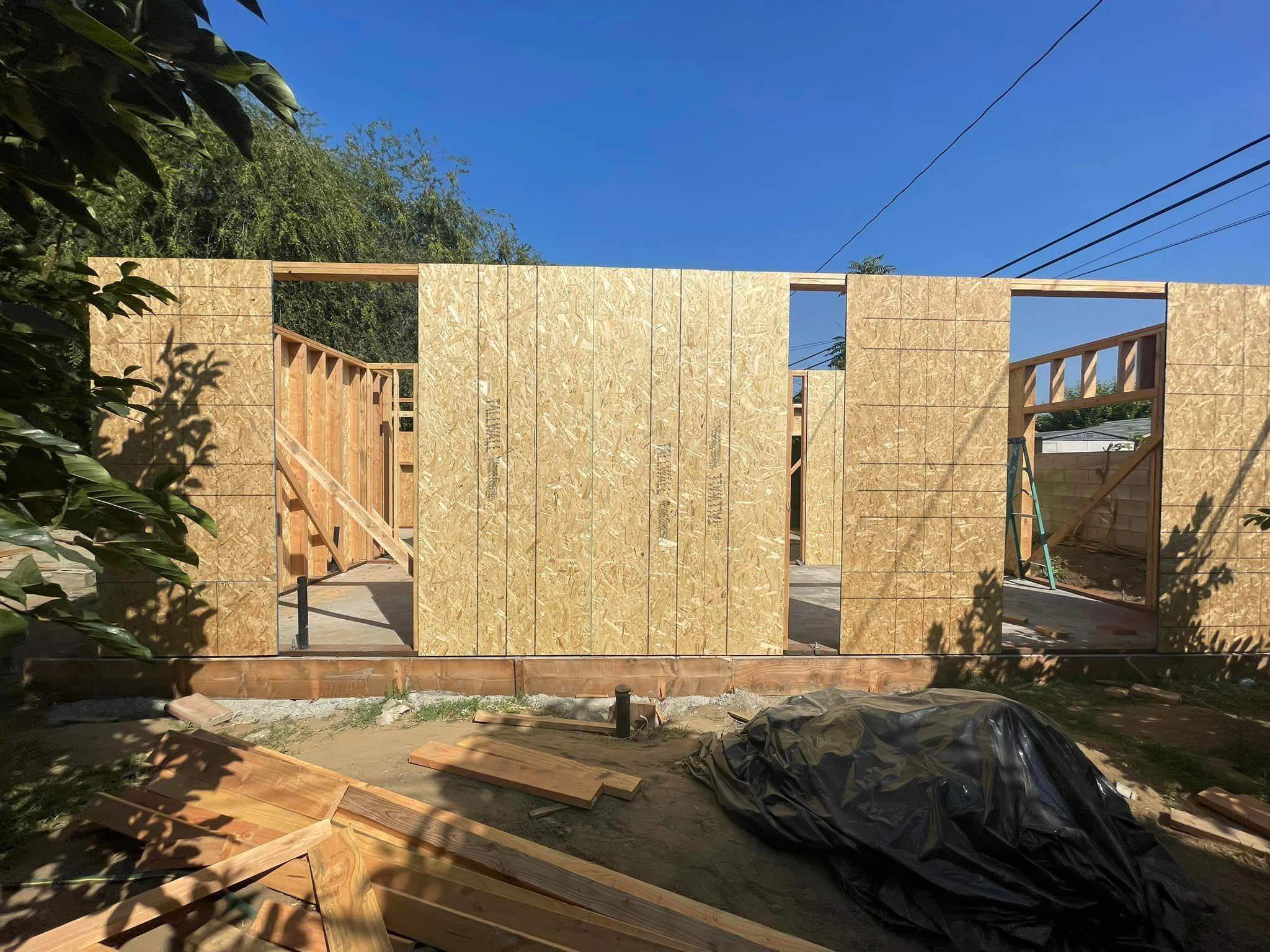 Room addition wall framing and sheathing in progress by Hillstar Construction