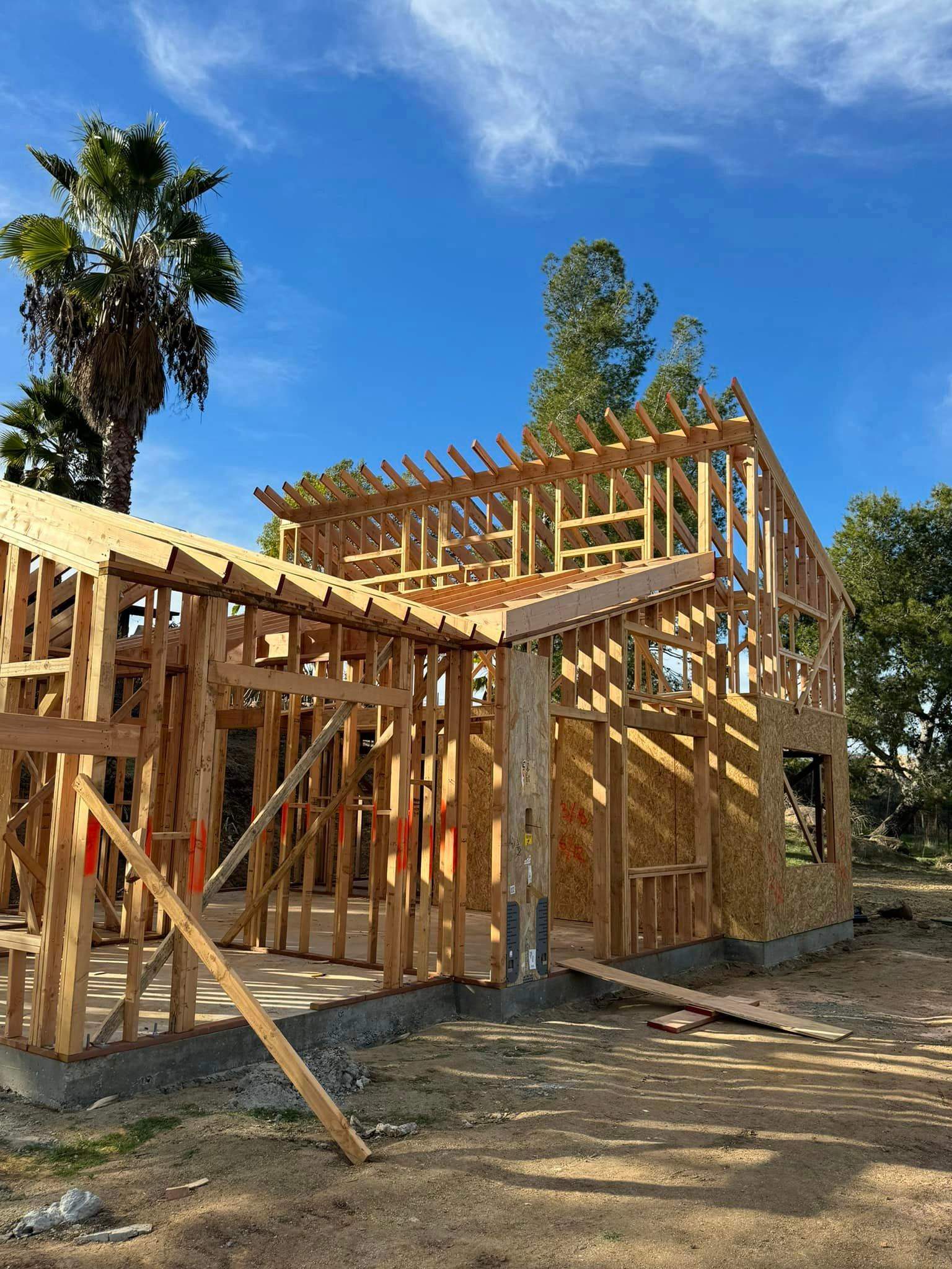 Two-story home addition framing with rafters by Hillstar Construction