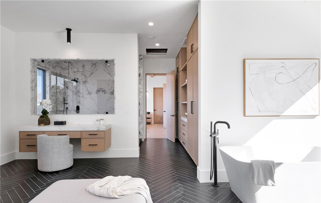 Bathroom remodel with freestanding tub and herringbone tile floor by Hillstar Construction
