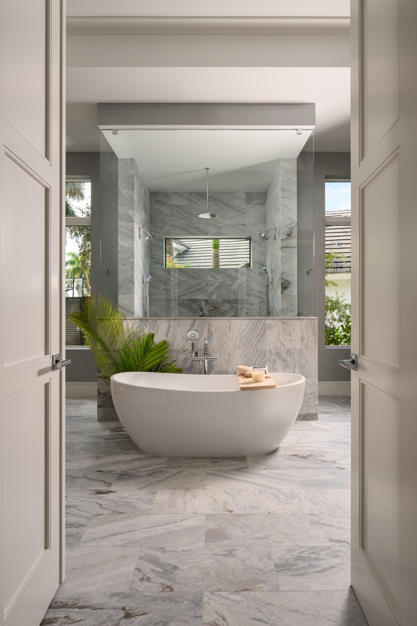 Luxury bathroom with marble tile and freestanding soaking tub by Hillstar Construction in Los Angeles