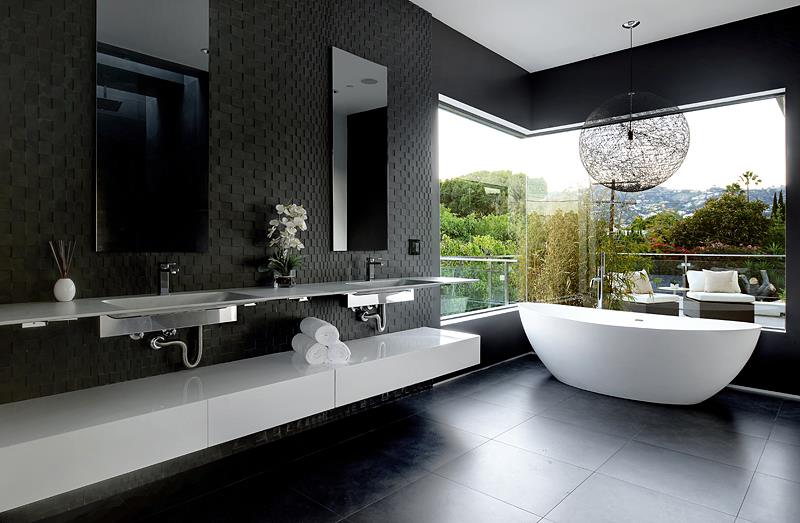Luxury bathroom with freestanding tub and panoramic view by Hillstar Construction in Los Angeles