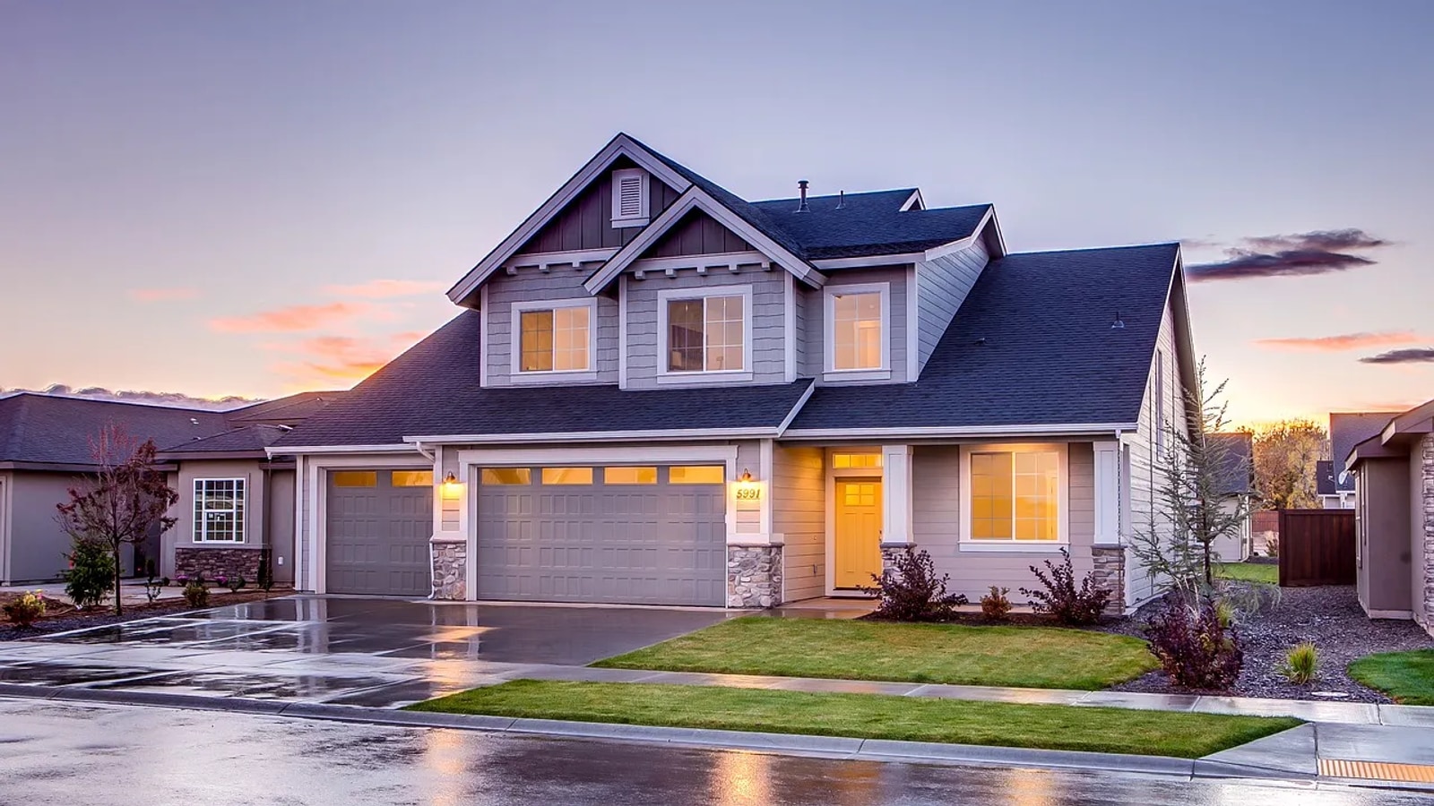 Two-story residential home with a freshly installed cool-rated architectural shingle roof at dusk
