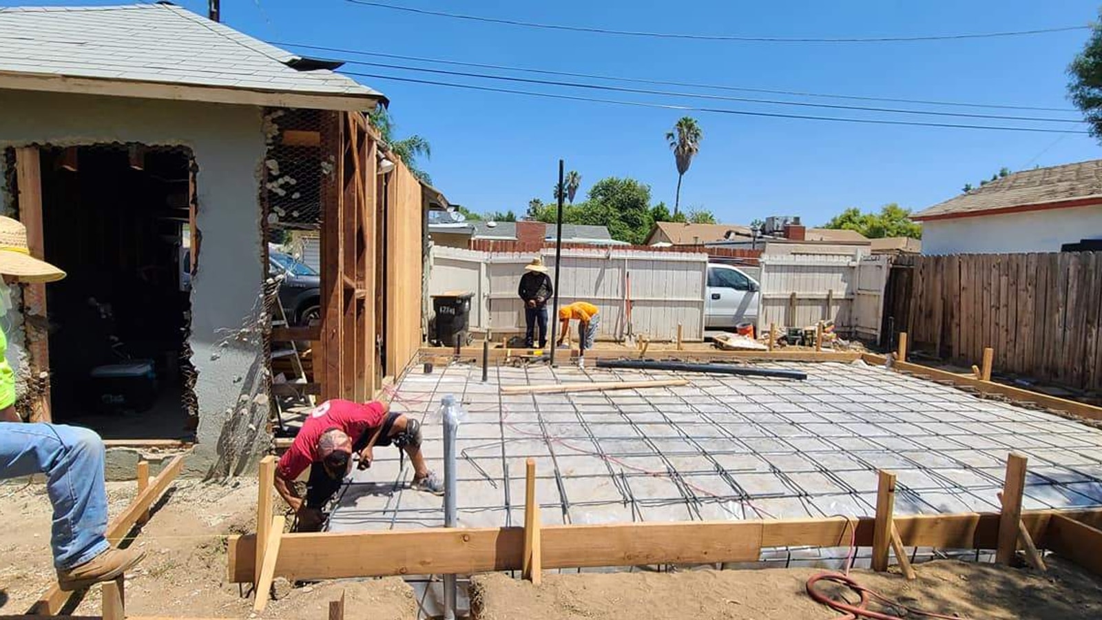 Hillstar crew opening up an existing garage wall and forming a new attached slab