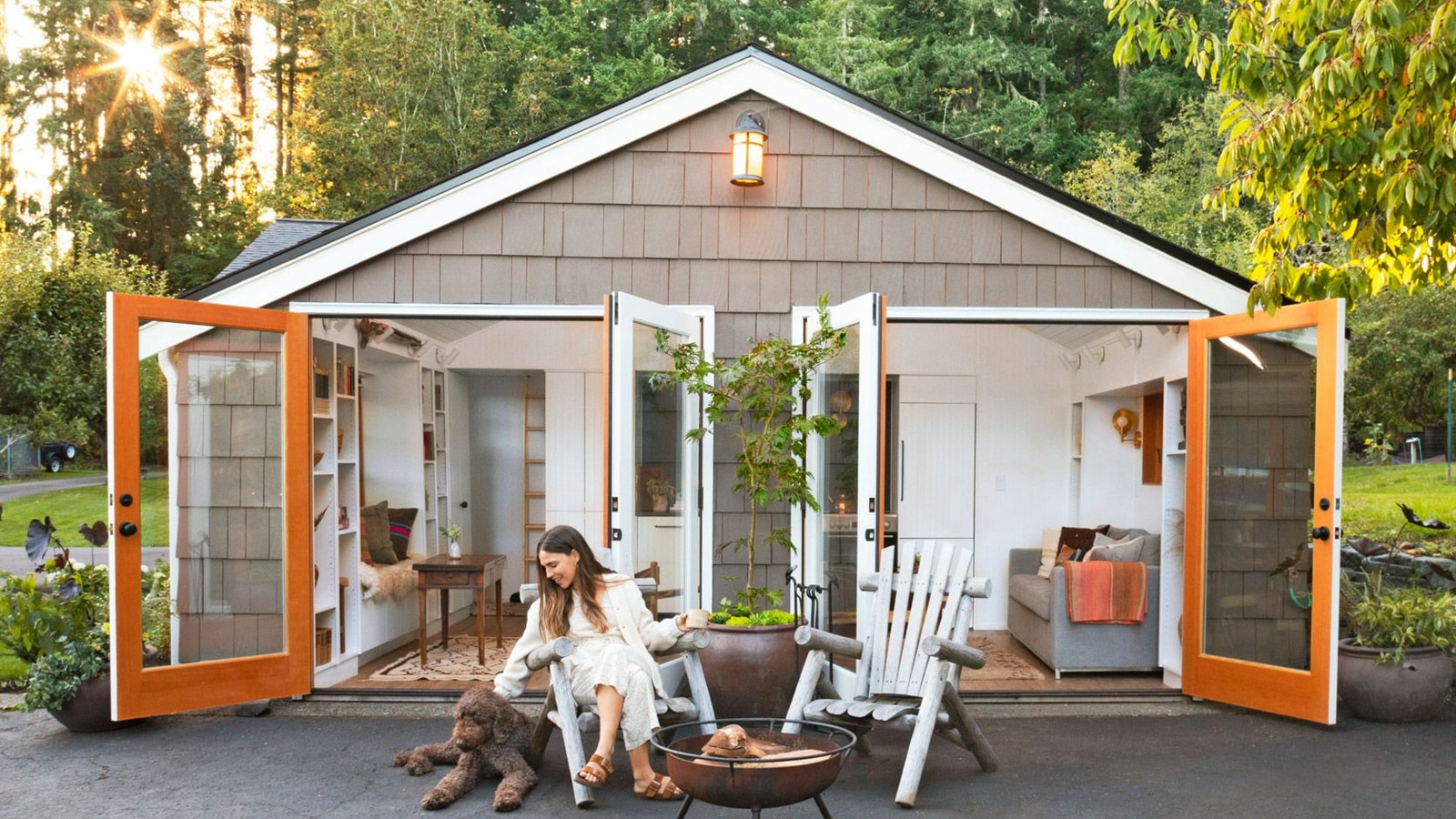 Cottage-style detached garage converted to a living space with French doors open and warm interior