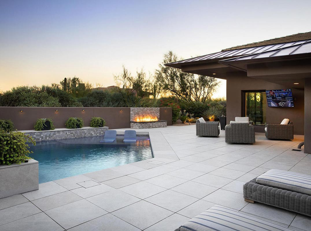 Paver patio with pool and fire feature by Hillstar Construction in Los Angeles