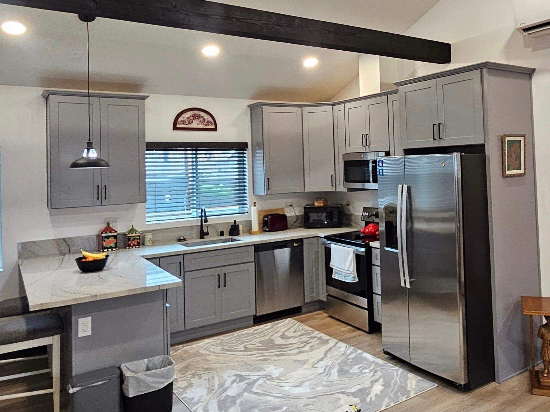 Modern gray shaker kitchen remodel with stainless steel appliances