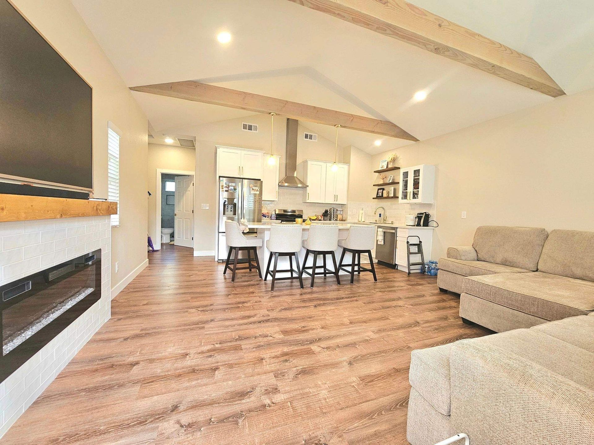 Open concept living kitchen with vaulted beam ceiling