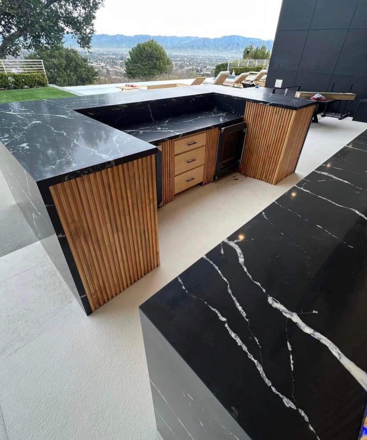 Outdoor kitchen with built in BBQ and pool mountain view