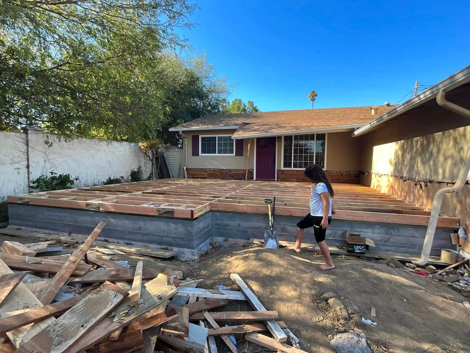Floor framing for a detached ADU behind an existing single-story home on a Hillstar Construction Inc jobsite