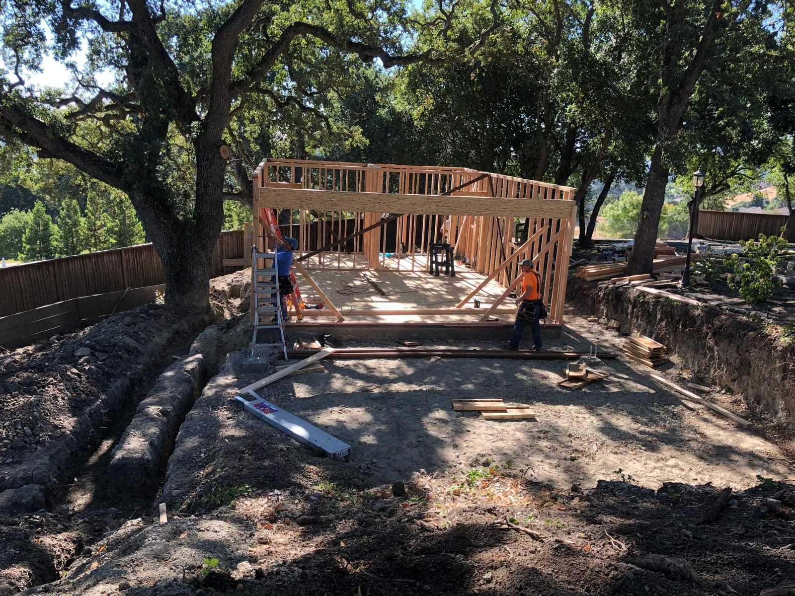 ADU framing under mature oak trees on a Hillstar Construction Inc jobsite