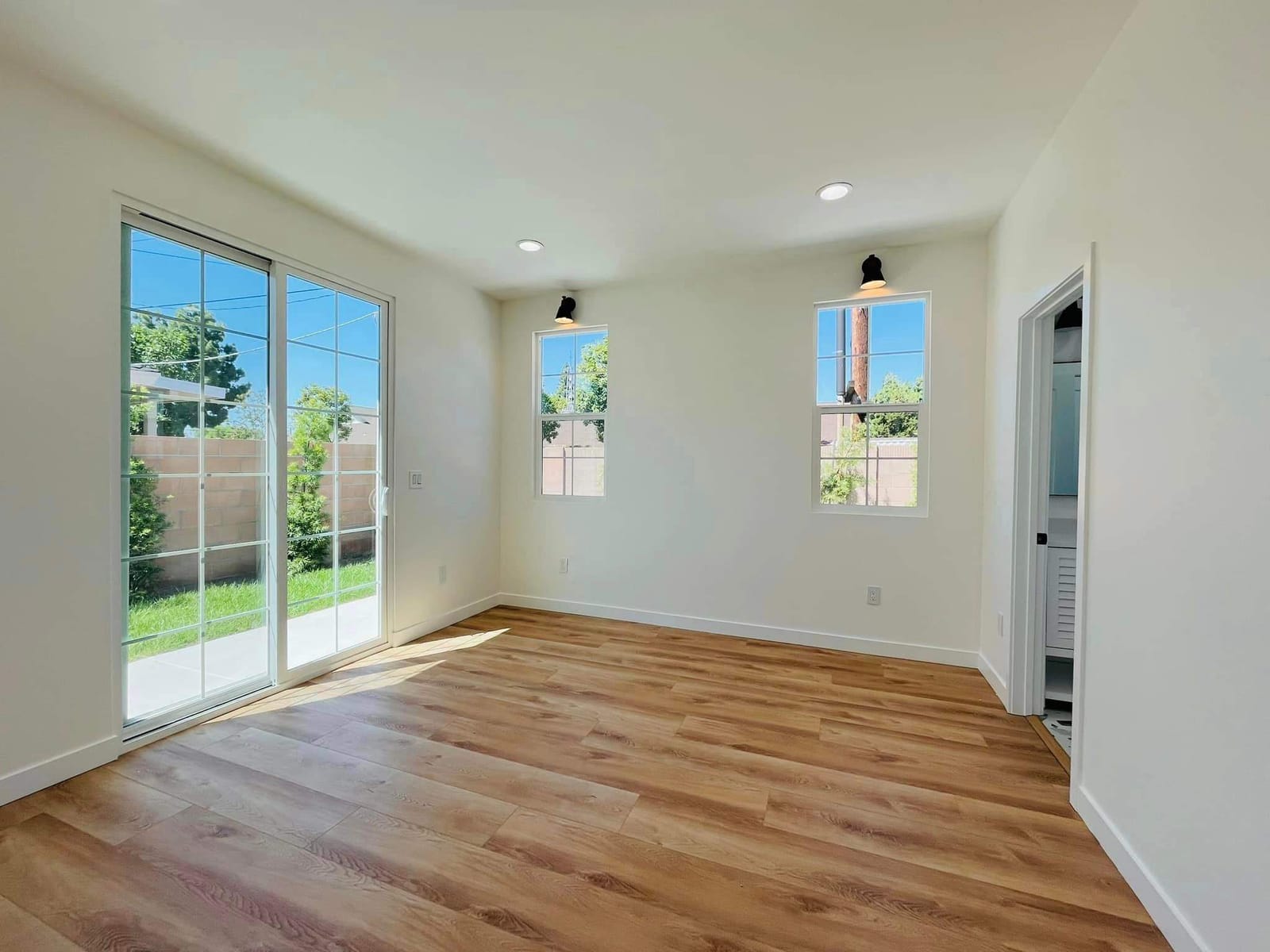 Finished ADU living room by Hillstar Construction Inc with new windows and wood flooring