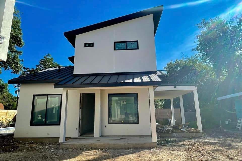 Two-story Hillstar Construction Inc project under construction with metal roof and new windows