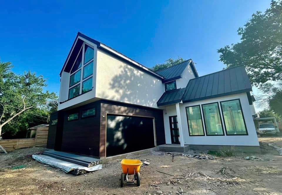 Two-story modern unit by Hillstar Construction Inc nearing completion, with garage bay