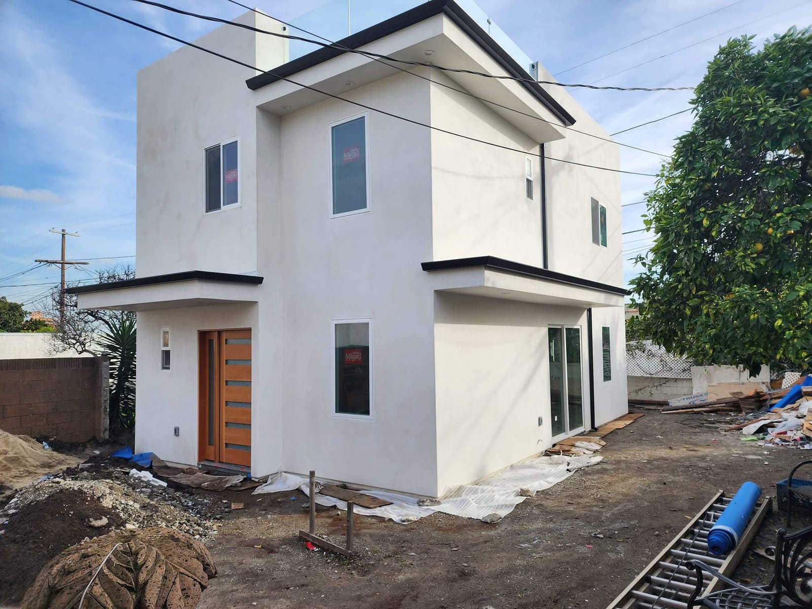 Two-story ADU by Hillstar Construction Inc with stucco complete and windows installed