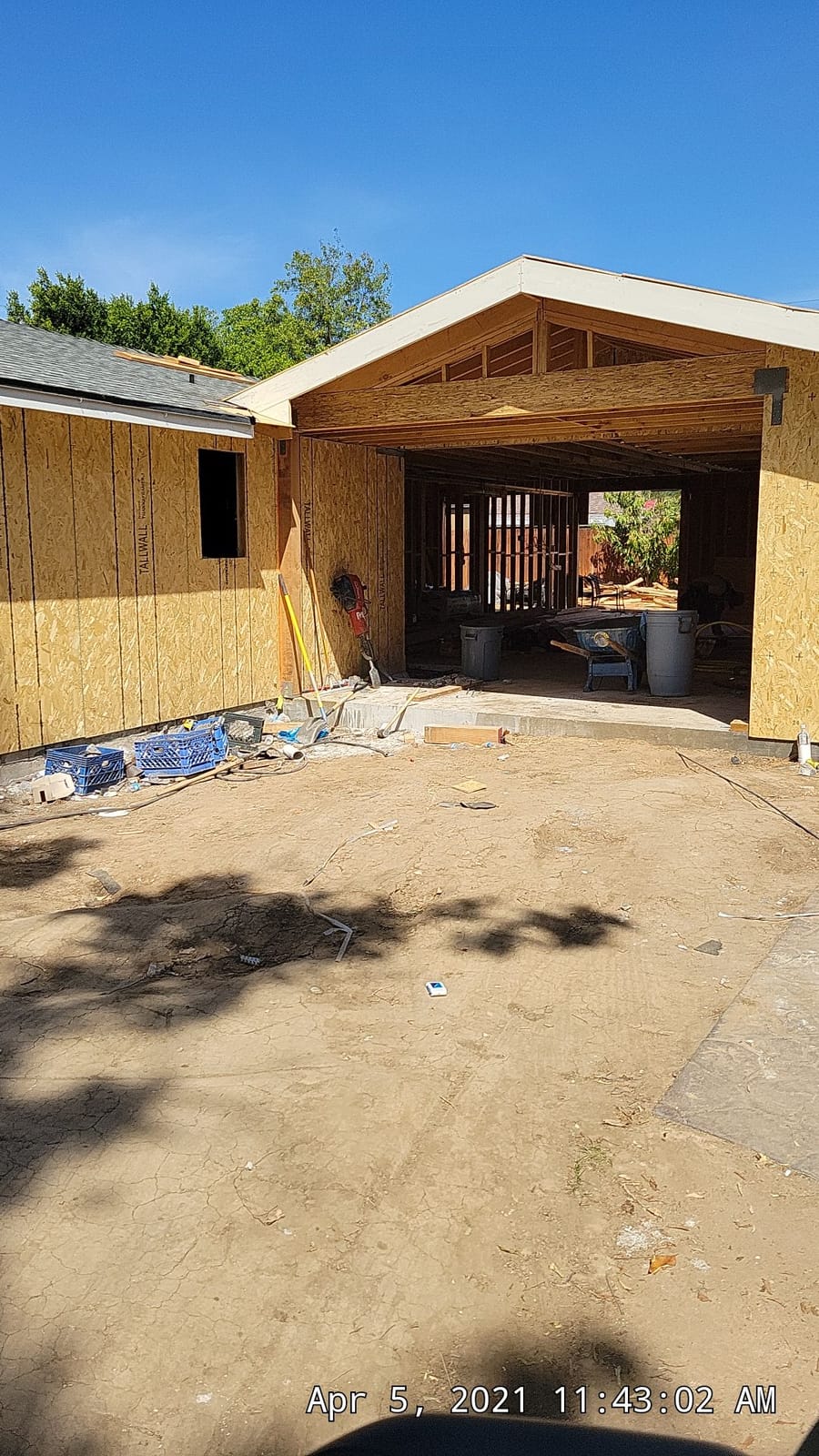Interior of a garage under conversion by Hillstar Construction Inc with new framing and sheathing
