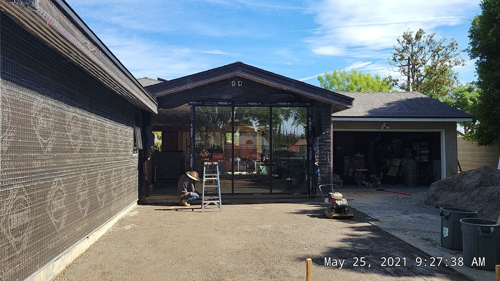 Garage-sized shell with weather wrap and windows in, before stucco, on a Hillstar Construction Inc jobsite
