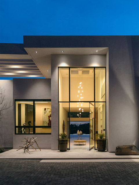 Finished modern stucco home entry at dusk by Hillstar Construction